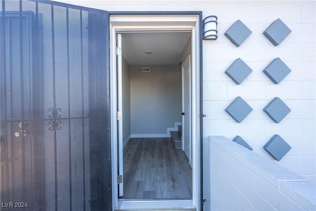 doorway to property featuring a garage and visible vents