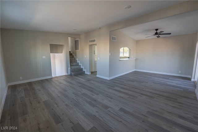 unfurnished room featuring dark wood-type flooring and ceiling fan