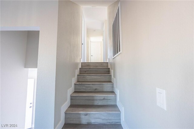 staircase featuring hardwood / wood-style flooring