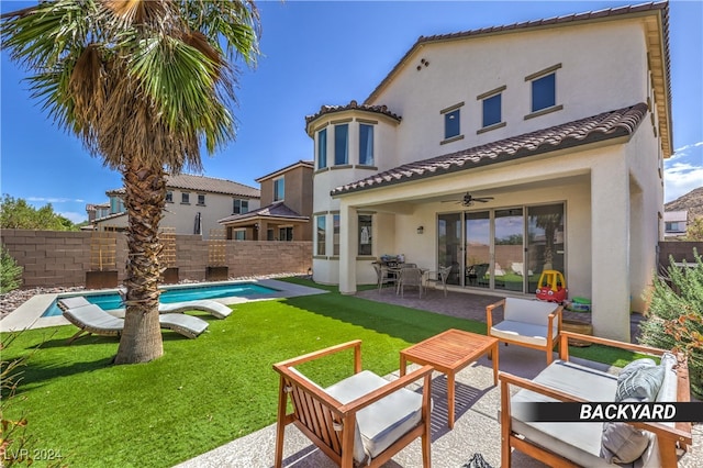 back of house with a patio, a lawn, a fenced in pool, outdoor lounge area, and ceiling fan