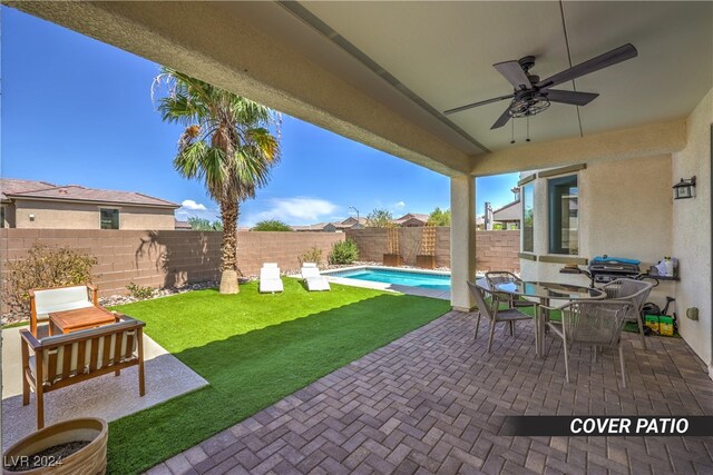 view of patio / terrace featuring a fenced in pool, a grill, and ceiling fan