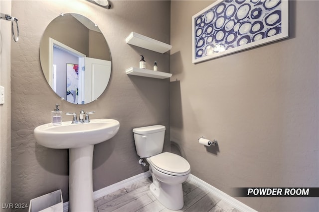 bathroom featuring toilet and hardwood / wood-style flooring