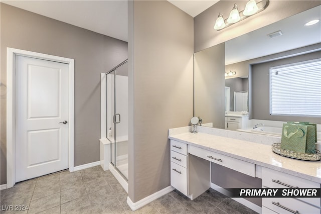 bathroom featuring plus walk in shower, tile patterned flooring, and vanity