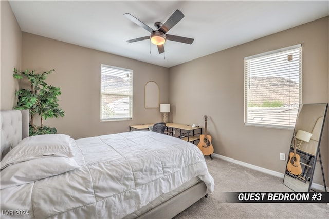 bedroom featuring light carpet, multiple windows, and ceiling fan