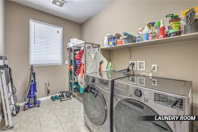 laundry room with washing machine and clothes dryer and light tile patterned floors