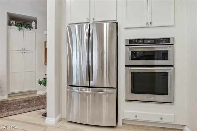 kitchen with stainless steel appliances and white cabinets