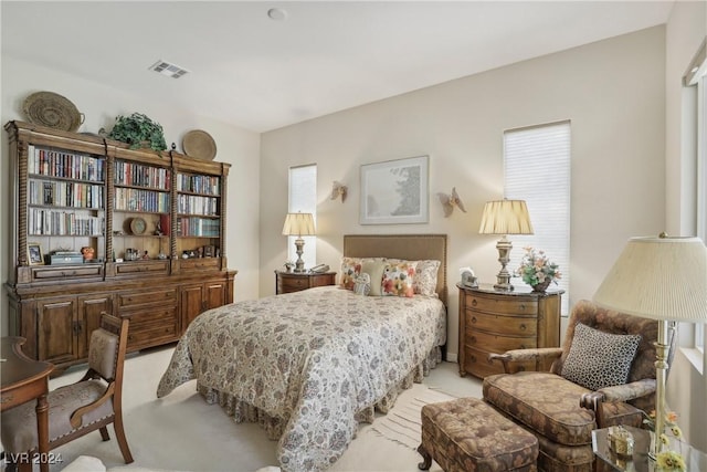 bedroom featuring light carpet