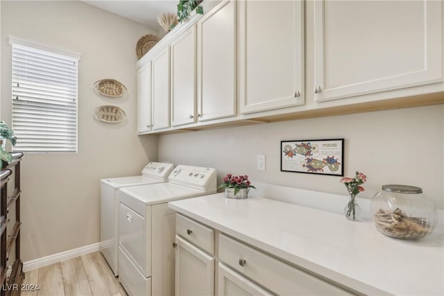 clothes washing area with cabinets, separate washer and dryer, and light hardwood / wood-style floors