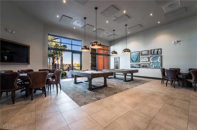 game room with a towering ceiling, billiards, and light parquet floors