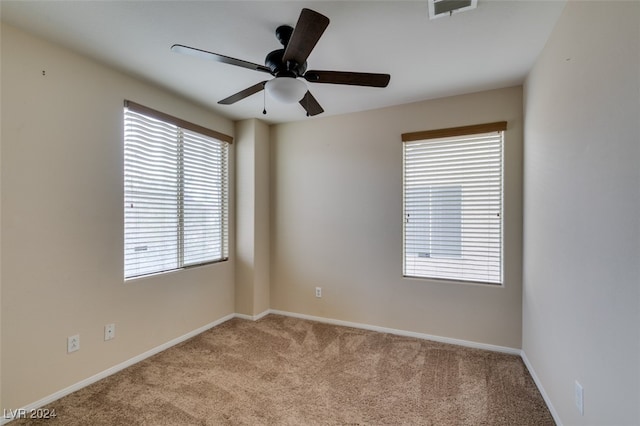 spare room with light carpet and ceiling fan