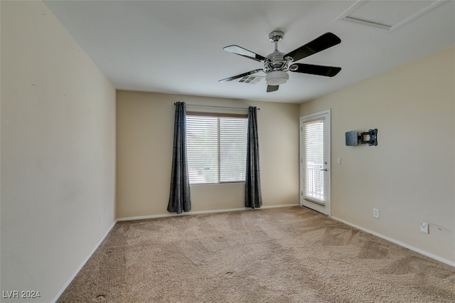 carpeted empty room featuring ceiling fan