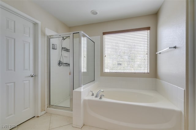 bathroom with independent shower and bath and tile patterned floors