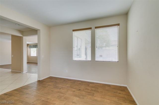 empty room with a wealth of natural light and light wood-type flooring