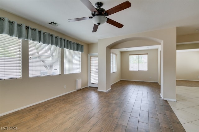 spare room featuring light hardwood / wood-style flooring and ceiling fan