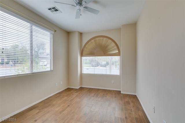 spare room featuring light wood-type flooring and ceiling fan