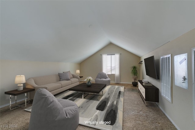 living room with lofted ceiling and carpet flooring