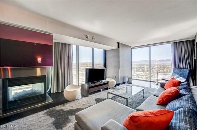 4381 W Flamingo Rd Unit 3021, Las Vegas, NV 89103 - living room with a wall of windows, a multi sided fireplace, and a healthy amount of sunlight