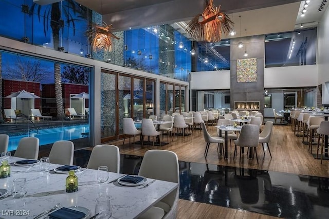 dining space featuring a high ceiling and wood finished floors