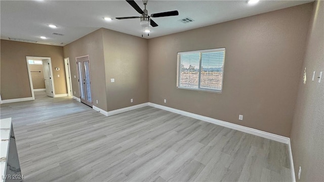 unfurnished room with ceiling fan and light hardwood / wood-style floors