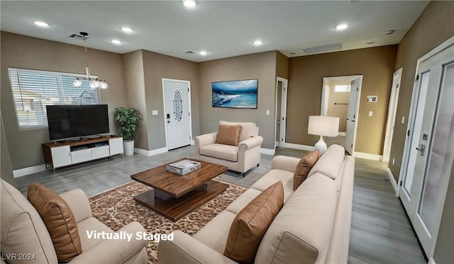 living room featuring hardwood / wood-style floors and a chandelier