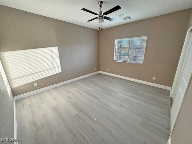 empty room featuring light wood-type flooring and ceiling fan