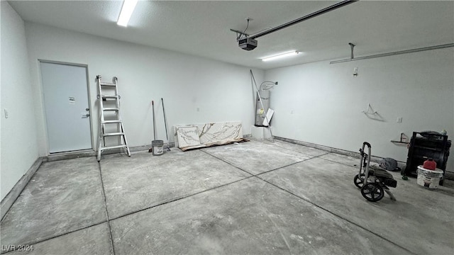 garage with secured water heater and a garage door opener