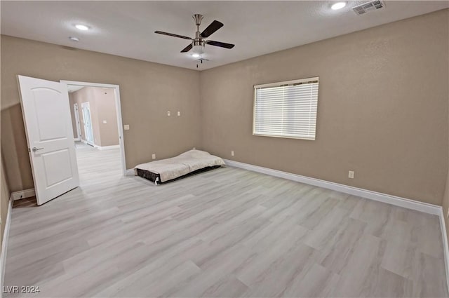 unfurnished bedroom featuring ceiling fan and light hardwood / wood-style floors