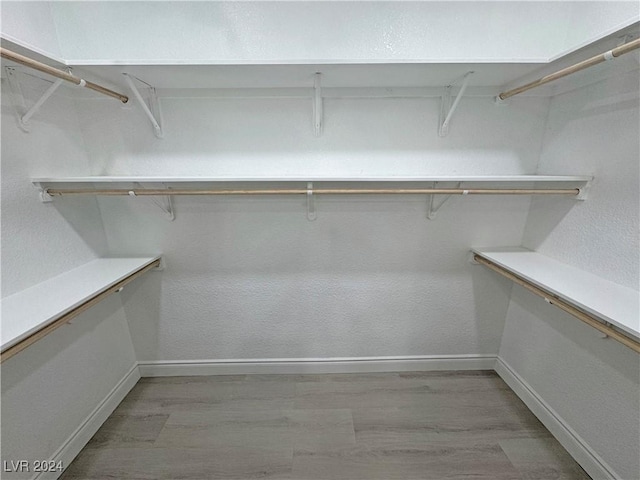 spacious closet with light hardwood / wood-style floors