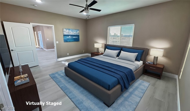 bedroom featuring light hardwood / wood-style floors and ceiling fan