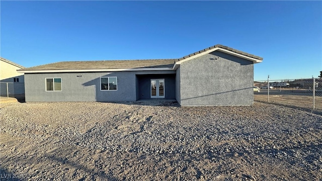 rear view of house featuring french doors