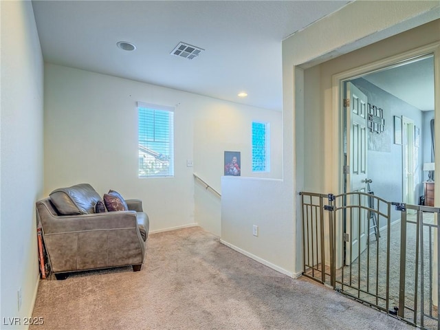 living area featuring light colored carpet