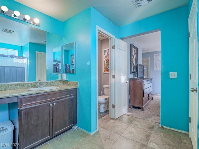 bathroom featuring vanity, toilet, and walk in shower