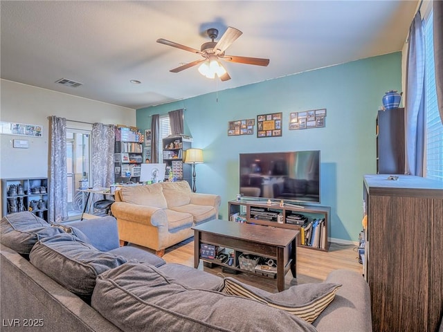 living room with ceiling fan and light hardwood / wood-style flooring