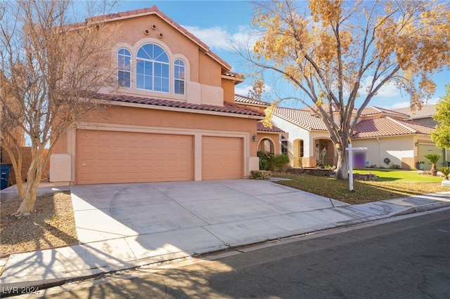 mediterranean / spanish-style house featuring a garage