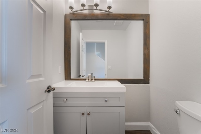 bathroom featuring toilet and vanity