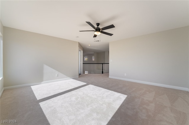 unfurnished room featuring ceiling fan and light carpet