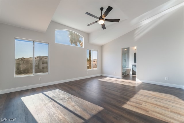 unfurnished room featuring plenty of natural light, high vaulted ceiling, ceiling fan, and dark hardwood / wood-style floors