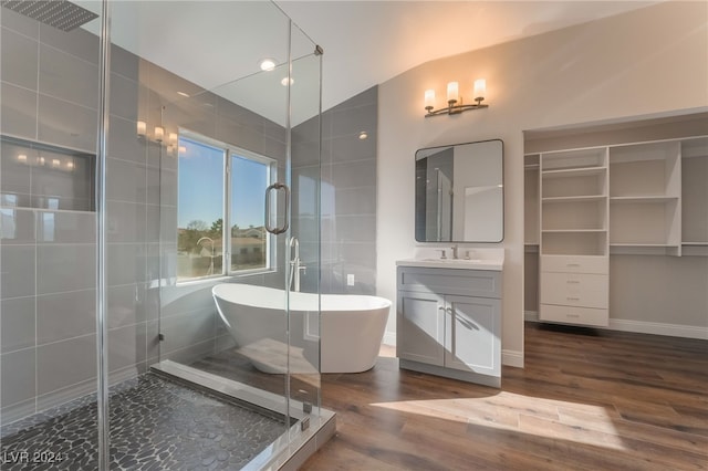 bathroom featuring lofted ceiling, shower with separate bathtub, wood-type flooring, and vanity