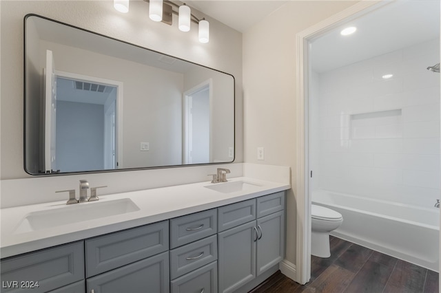 full bathroom featuring toilet, vanity, and tub / shower combination