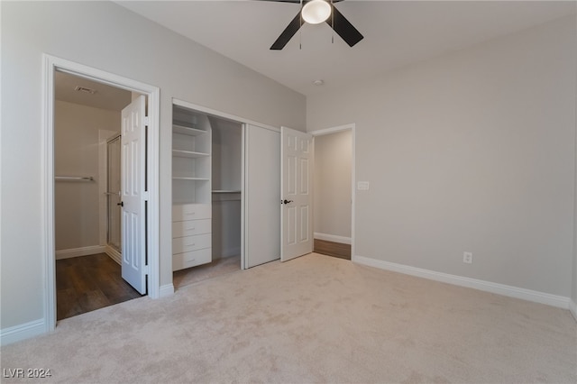 unfurnished bedroom with a closet, carpet floors, and ceiling fan