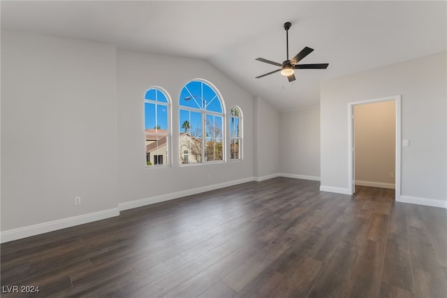 spare room with lofted ceiling, ceiling fan, and dark hardwood / wood-style floors