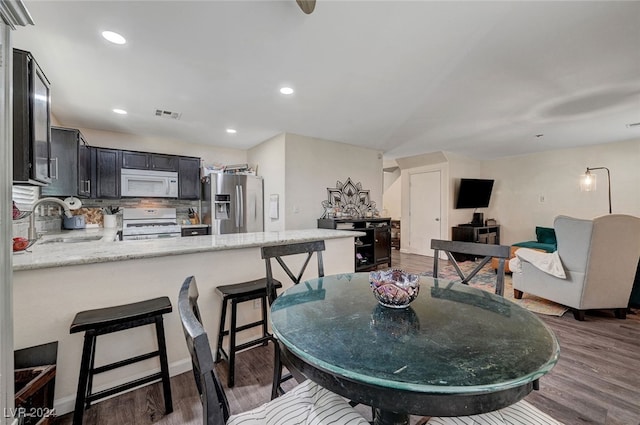 dining space featuring sink and dark hardwood / wood-style floors