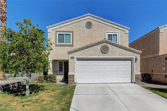 view of property with a garage and a front yard