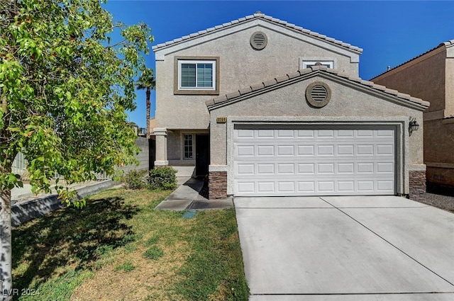 view of front of house featuring a garage and a front yard