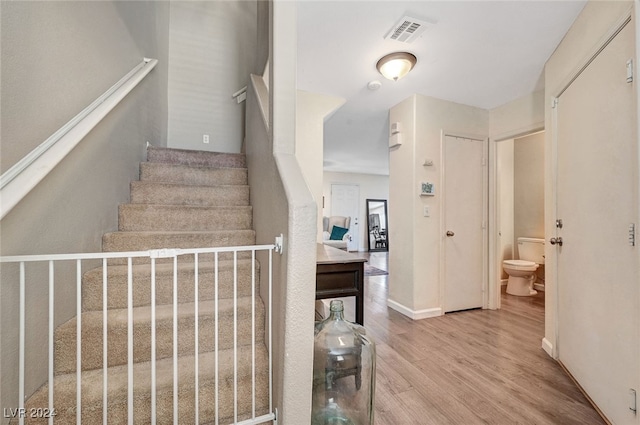 stairway with hardwood / wood-style floors