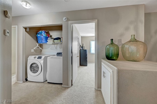 washroom with light colored carpet and independent washer and dryer