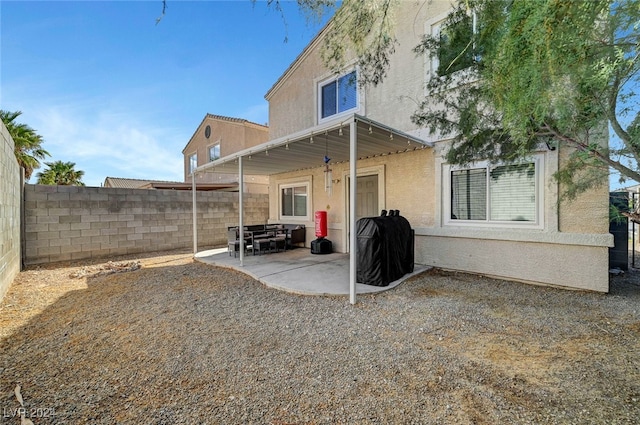 back of property with a patio