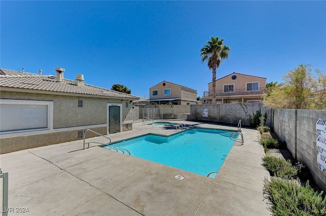 view of swimming pool with a patio area