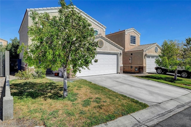 view of front facade featuring a garage and a front lawn