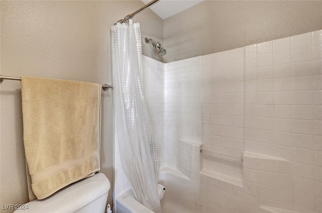 bathroom with toilet and shower / bath combo with shower curtain